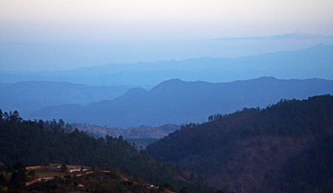 Rolling peaks of mountains stretch into the distance.