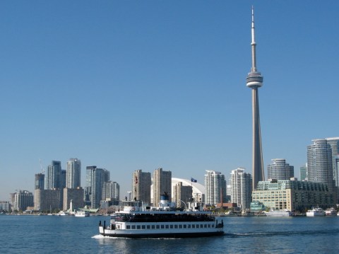 Midday view of a ferry and across the water the dramatic Toronto skyline.