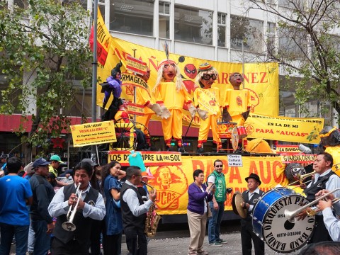A band plays in front of colorful effigies prepared for the Anos Viejos festival in Quito.