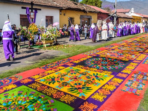 Locals reenact biblical scenes with processions walking over handmade dyed sawdust carpets on Good Friday in colonial town with most famous Holy Week celebrations in Latin America.