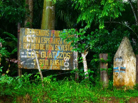 A wooden sign at the border between Nicaragua and Costa Rica