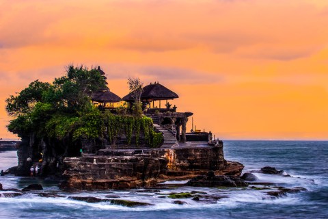 image of Pura Tanah Lot at sunset with orange skies