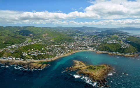 Aerial view of a city next to a turquoise sea