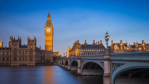 Big Ben and stone bridge illuminated at sunrise